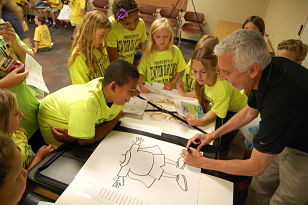 Jeff Nicholas showing children how to draw his favorite character.